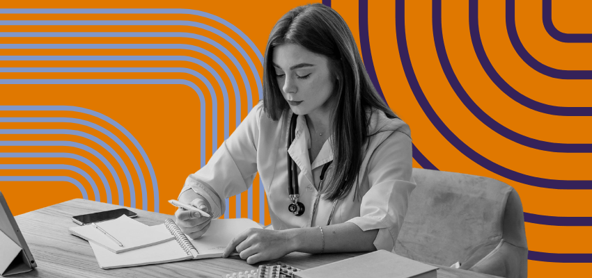 A home health agency administrator sits at her desk overlooking policies and procedures.